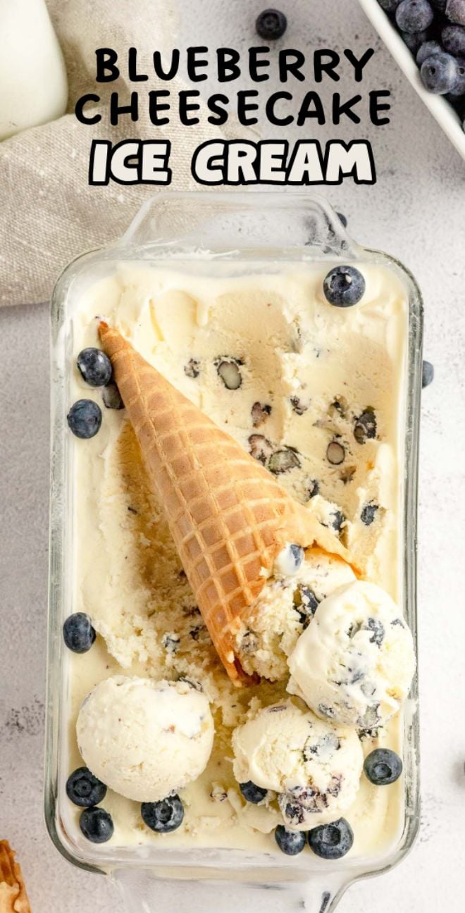 Rectangular dish of homemade cheesecake ice cream with scoops and a cone, topped with fresh blueberries for the perfect Blueberry Cheesecake Ice Cream treat.