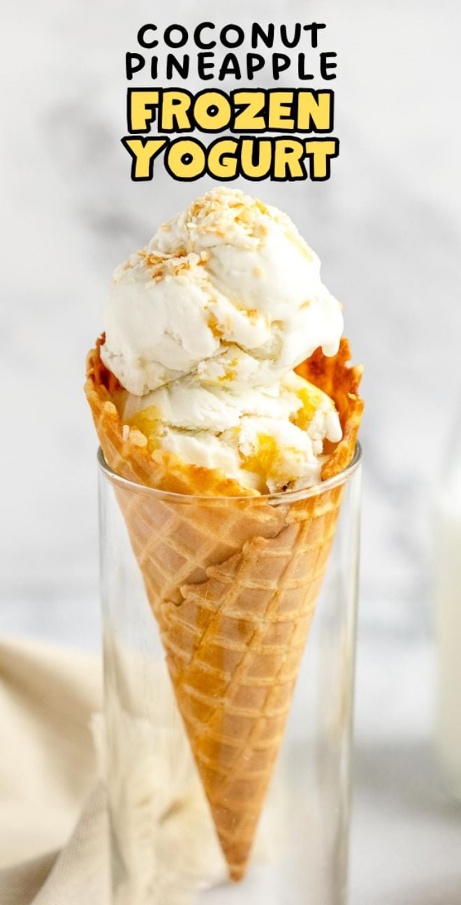 Waffle cone with coconut pineapple frozen yogurt, topped with toasted coconut, served in a clear glass—enjoy a taste of the best frozen yogurt recipe.