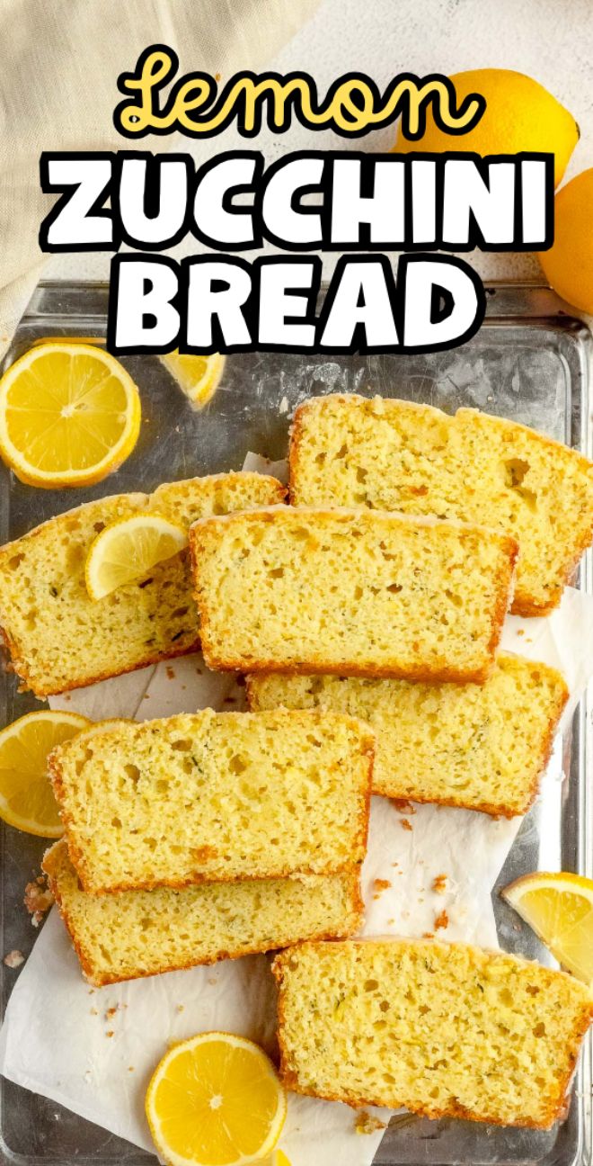 Slices of lemon zucchini bread arranged on a baking sheet, garnished with fresh lemon slices for a vibrant, tangy finish.