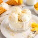 Four scoops of vanilla ice cream in a bowl with pineapple chunks and waffle cones on the side, perfect for those who love frozen yogurt ice cream or want to make froyo at home.