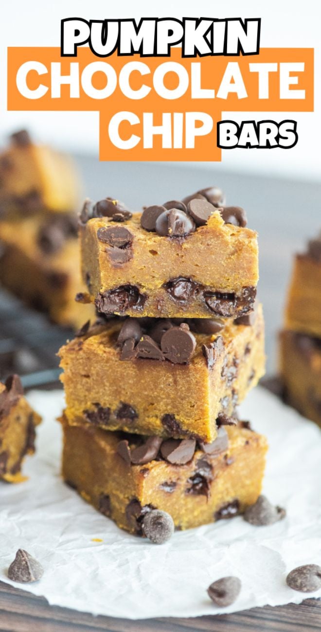 Three pumpkin squares with chocolate chips are stacked on parchment paper, an irresistible pumpkin and chocolate recipe topped with extra chocolate chips.