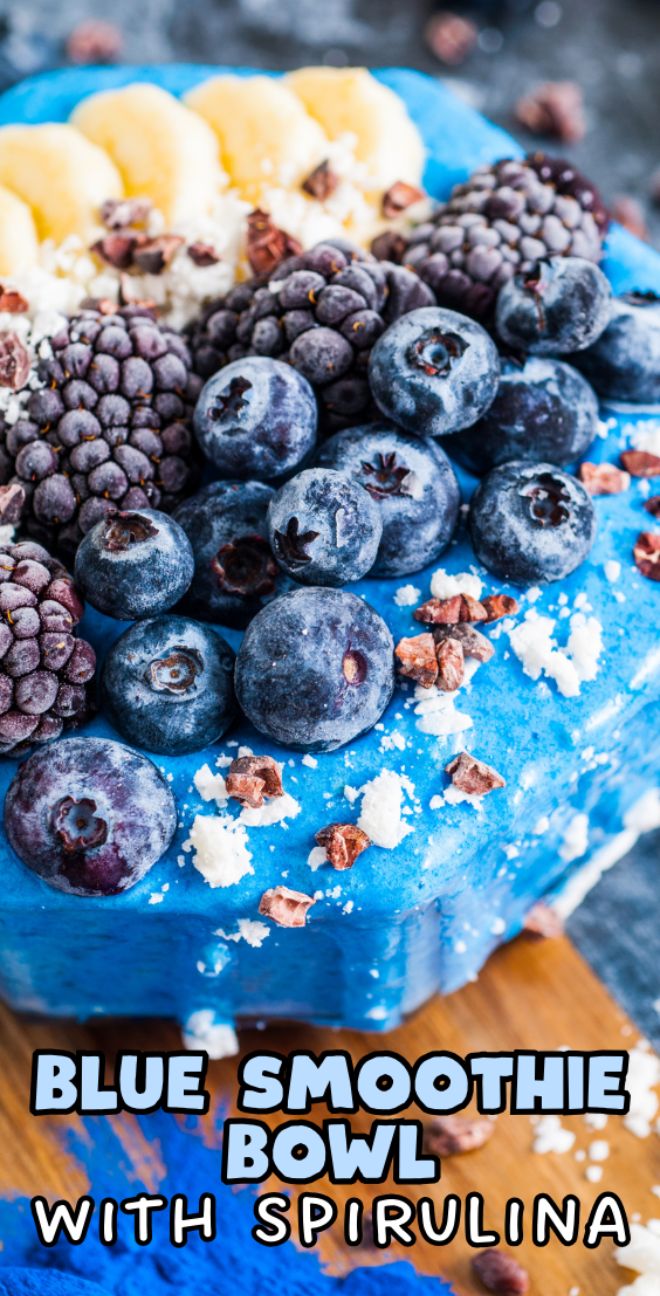 Blue Smoothie Bowl with Spirulina topped with blueberries, blackberries, banana slices, and white crumbles. Text reads: Blue Smoothie Bowl with Spirulina.
