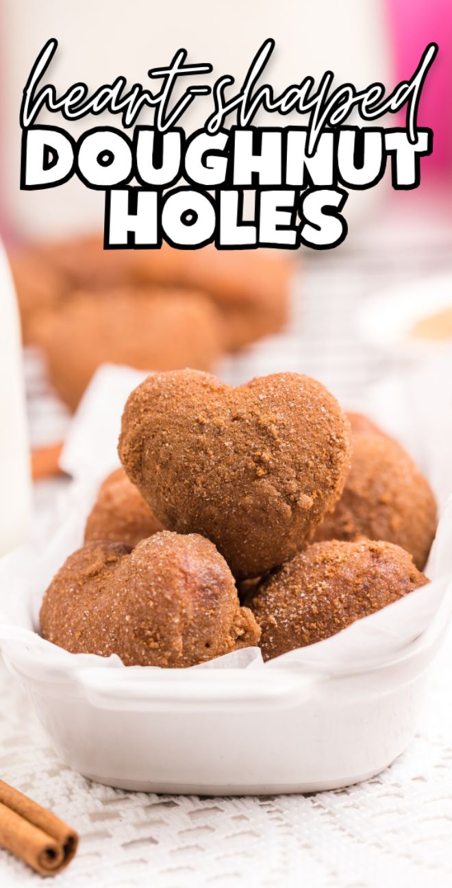 Heart-shaped doughnut holes in a white bowl, perfect for trying a fun mini doughnut recipe—text reads "heart-shaped doughnut holes.
