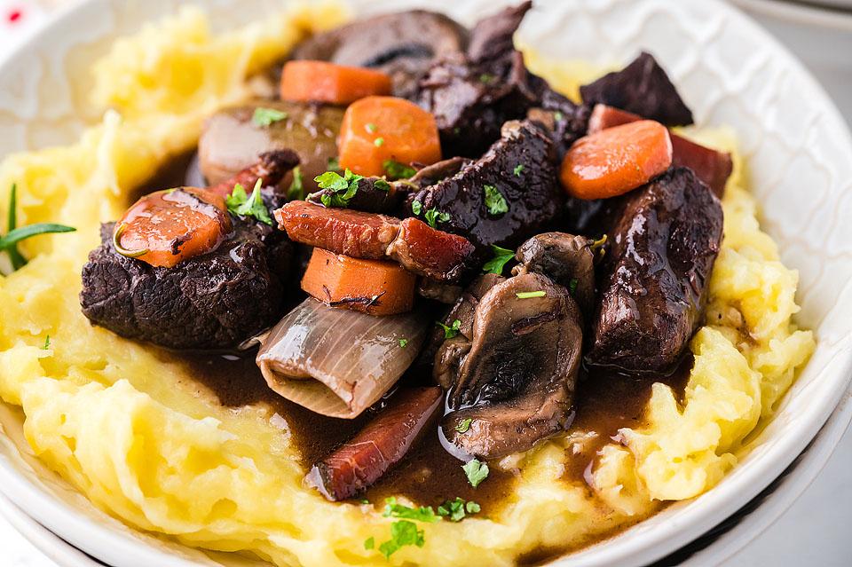 Boeuf bourguignon in a bowl with mash potatos.