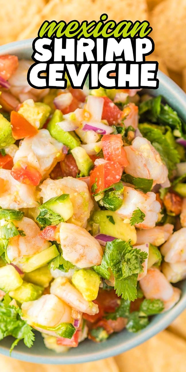 A blue bowl filled with Mexican shrimp ceviche containing shrimp, avocado, tomato, onion, and cilantro.