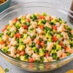 A bowl of shrimp ceviche with avocado, tomato, and cilantro, surrounded by tortilla chips and lime—this Mexican ceviche is bursting with fresh flavor.