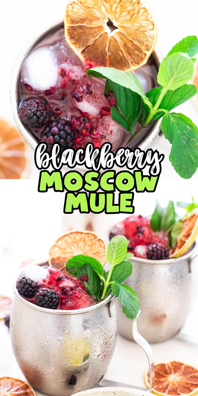 Two metal mugs filled with a blackberry Moscow Mule cocktail, garnished with mint and dried citrus.