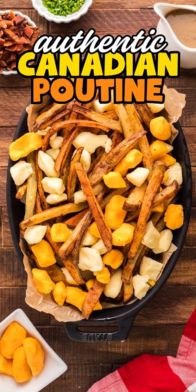 A tray of fries topped with cheese curds, surrounded by gravy, bacon, chives, and extra cheese on a table.