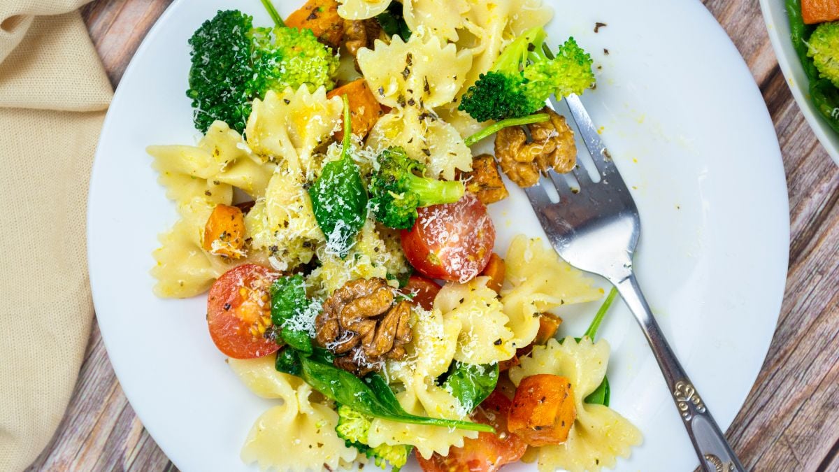 Vibrant salad with broccoli, pasta, roasted squash, and walnuts.