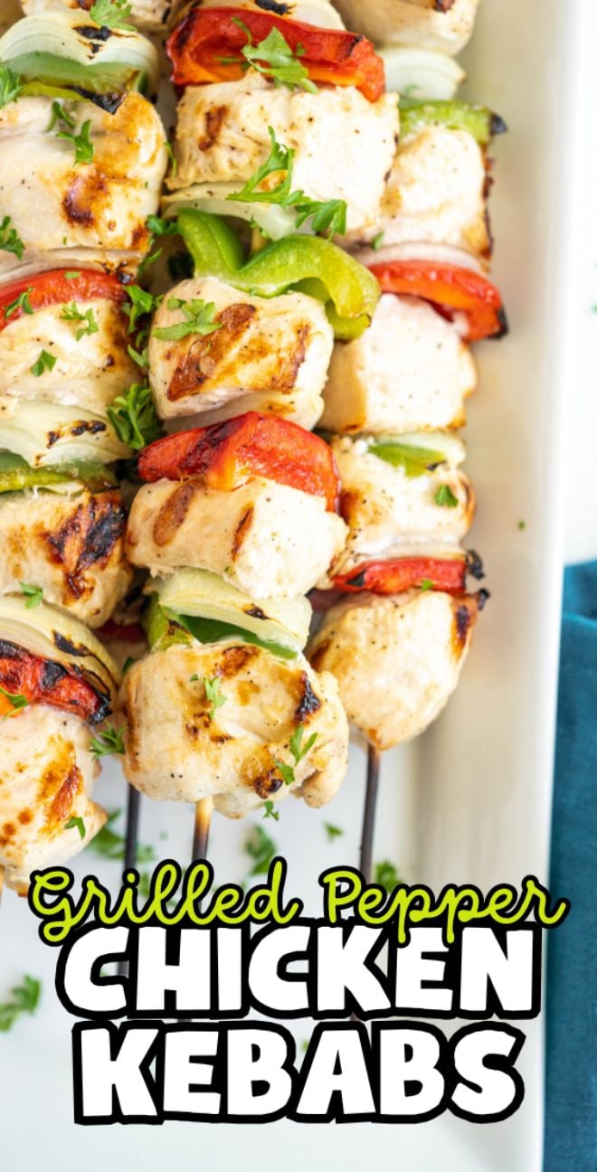 Grilled pepper and chicken kebabs with red and green peppers on skewers, garnished with fresh parsley, make for tasty chicken skewers perfect for any gathering.