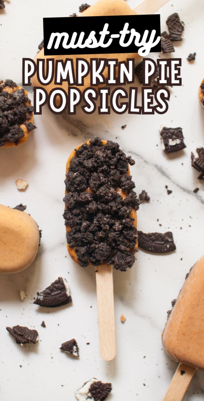 Pumpkin pie popsicle topped with crumbled cookies on a white surface, surrounded by more popsicles—a perfect fall treat for kids and a must-try recipe using pumpkin puree.