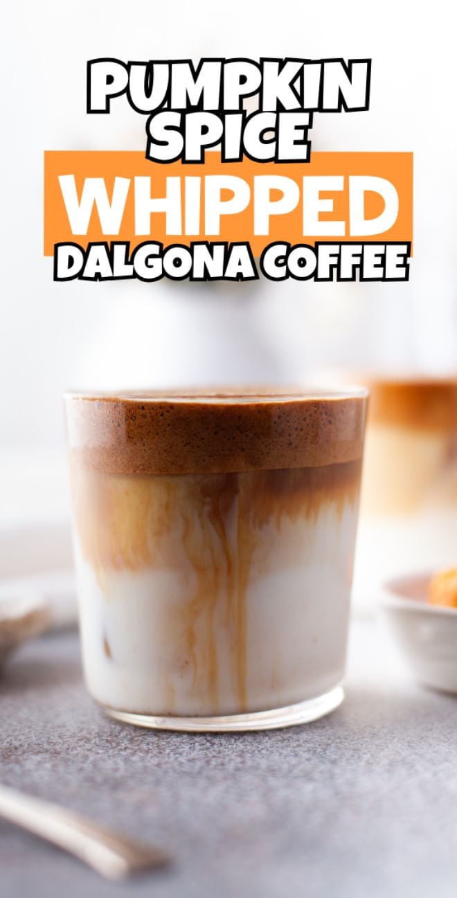 A glass of Pumpkin Spice Whipped Dalgona Coffee sits on a table, boasting layered cream and coffee foam—a perfect seasonal coffee recipe for those who crave autumn coffee flavour.