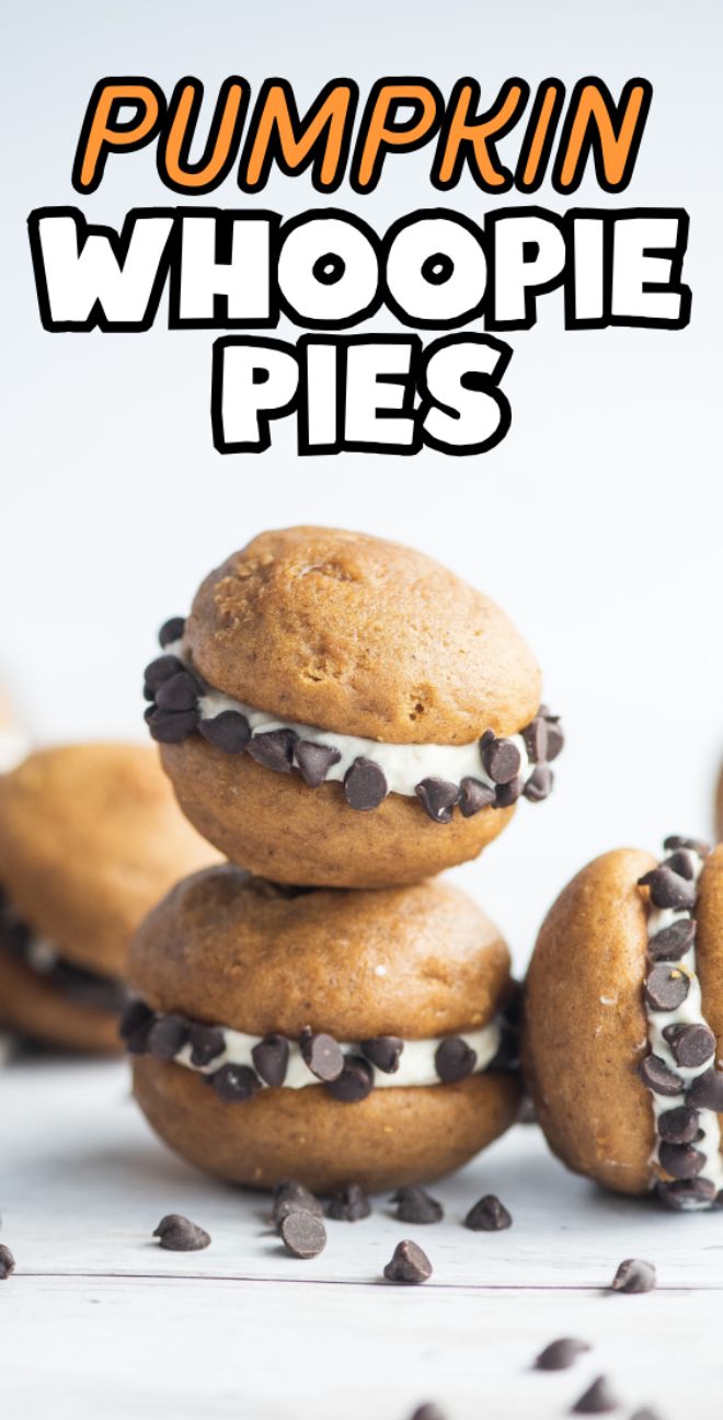 Two pumpkin gobs or whoopie pies with cream filling and chocolate chips, made with pumpkin pie filling, are stacked on a white surface.