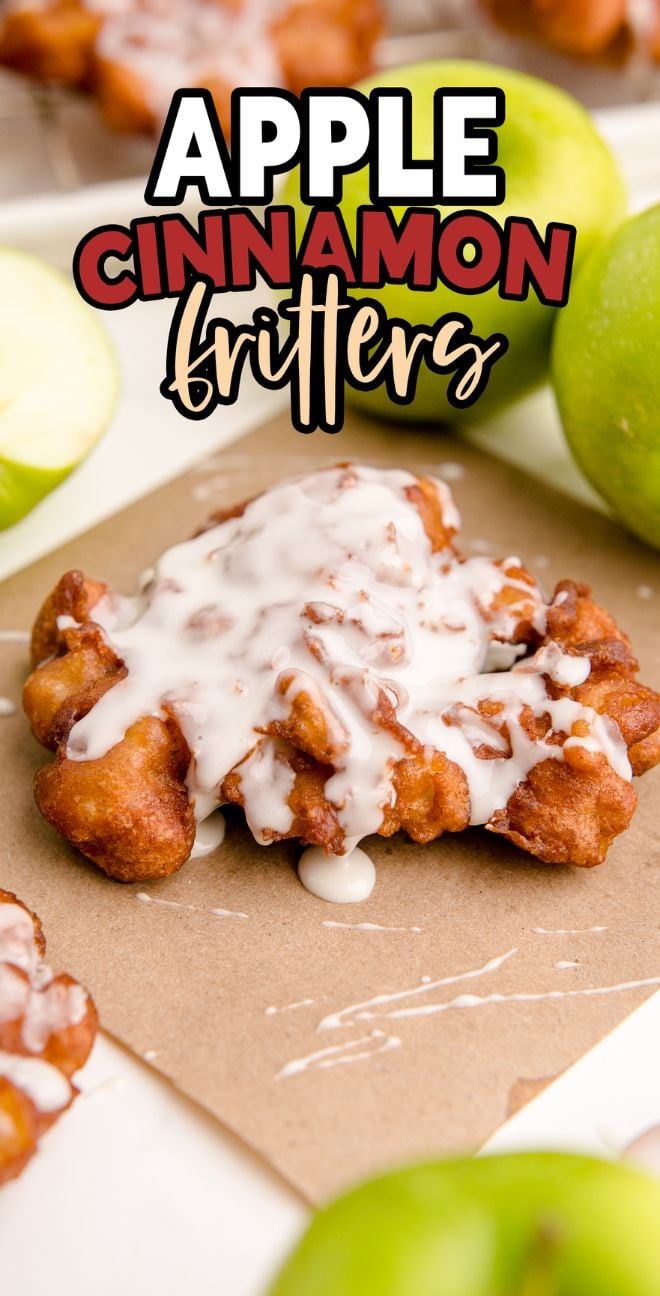 Apple Cinnamon Fritters topped with white glaze, surrounded by green apples on a light surface—a delicious nod to classic old fashioned fritters.
