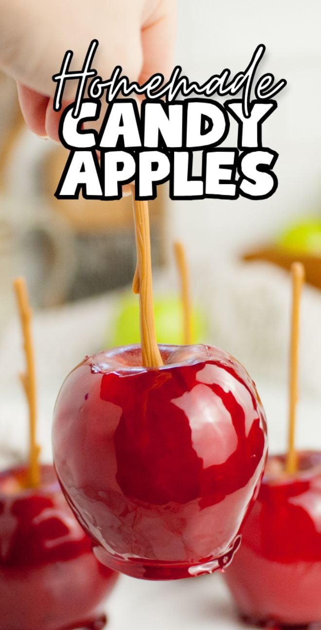 Hand holding a shiny red candy-coated apple on a stick, with "Homemade Candy Apples" text on top—perfect for learning how to make candy apples on a stick at home.