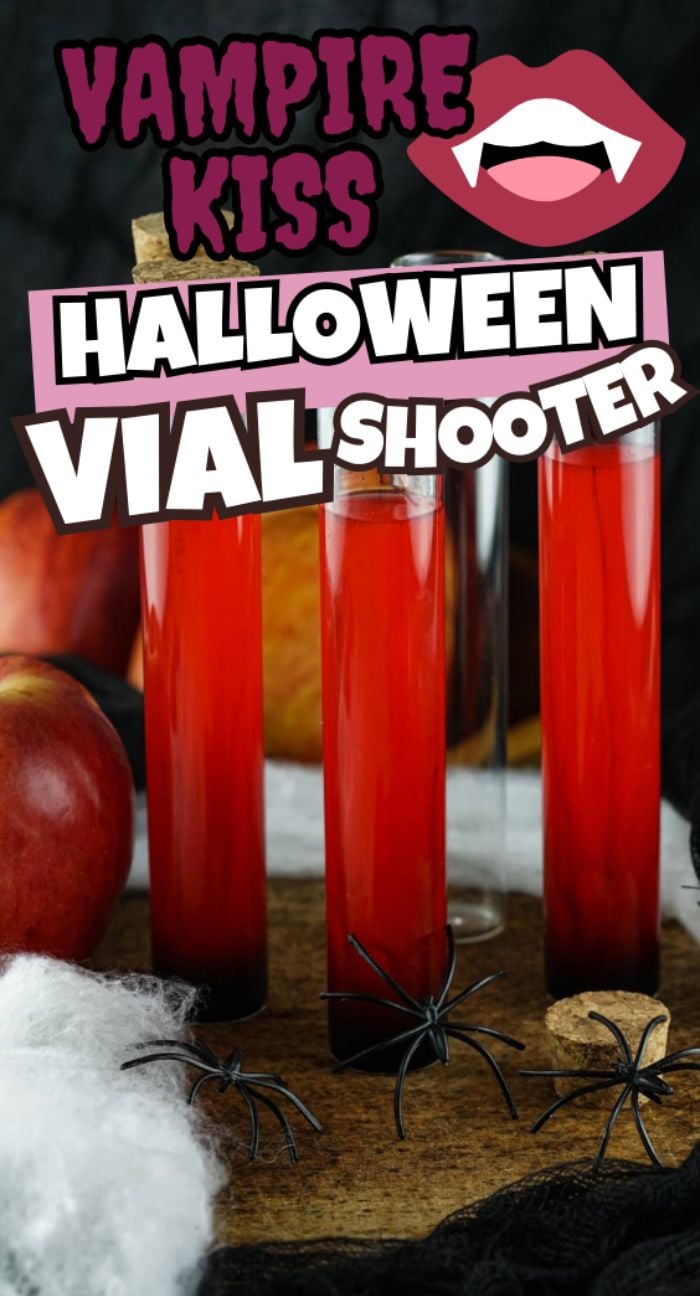 Three red vials with corks, Halloween decorations, apples, fake spiders, and "Vampire Kiss Halloween Vial Shooter" text highlight these fun Halloween rum shots perfect for your next spooky gathering.