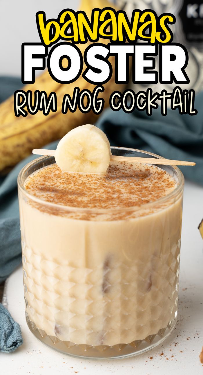 A glass of creamy Bananas Foster Rum Nog Cocktail, made with black spiced rum, topped with a banana slice and cinnamon.