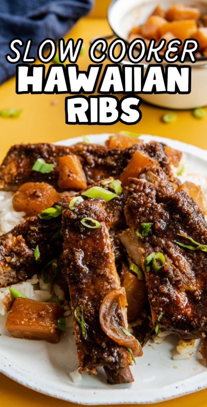 A plate of Crock pot ribs with pineapple chunks, served over rice and topped with green onions for a delicious Hawaiian twist.