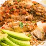 Baked chicken breasts topped with salsa, served with avocado slices and lime wedges on a white plate—an easy keto chicken recipe perfect for a quick meal.