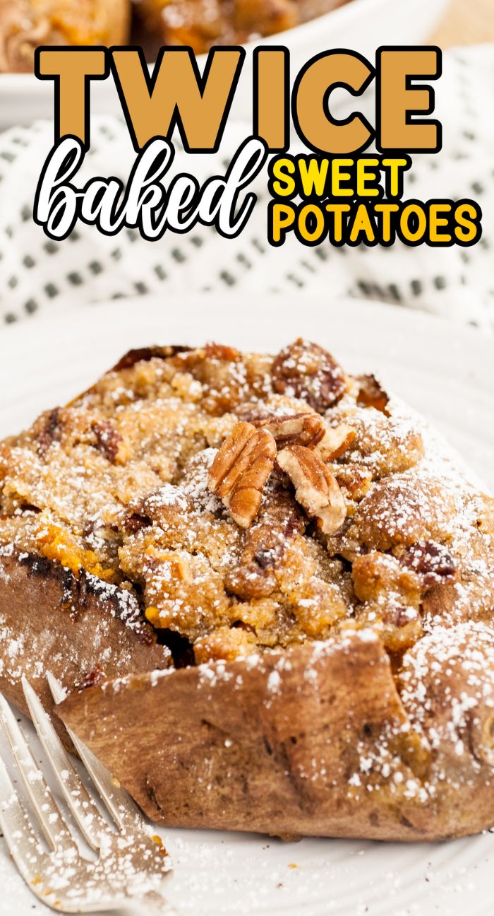 A twice-baked individual sweet potato casserole topped with pecans and powdered sugar, served on a white plate with a fork.