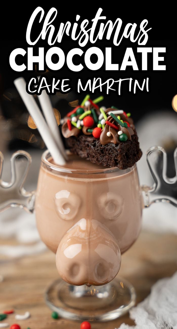 A festive chocolate cocktail, this reindeer glass of Christmas Chocolate Cake Martini is topped with a sprinkle-covered brownie and two straws—a merry boozy holiday drink to share.