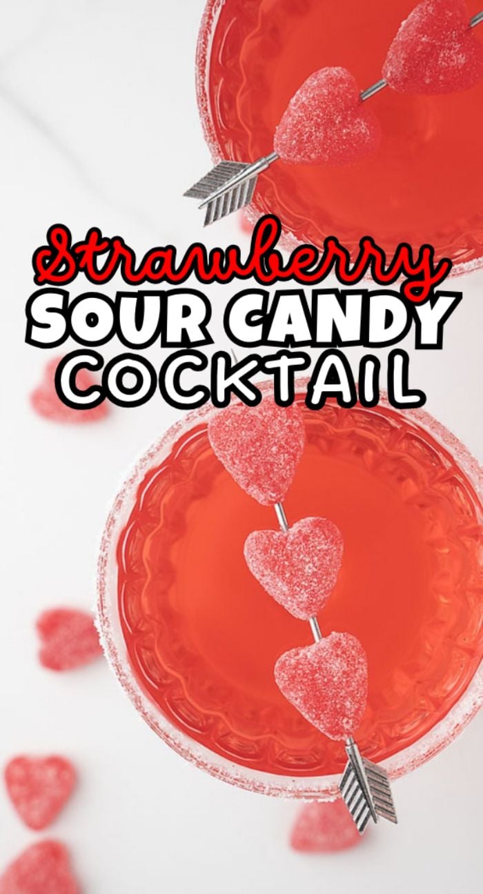 Two red cocktails topped with skewered heart-shaped sour candies, text reads "Strawberry Sour Candy Cocktail"—the perfect cocktail for Valentine's Day.