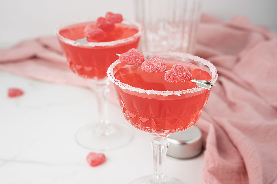 Food blogger, Bella Bucchiotti of xoxoBella, shares a recipe for a strawberry sour candy cocktail for Valentine's Day or Galentine's! You will love this mixed drink with sour candy, strawberry rum and sour strawberry schnapps. 