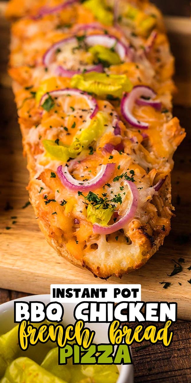 French bread pizza topped with chicken, cheese, red onions, pepperoncini, and herbs on a wooden board.