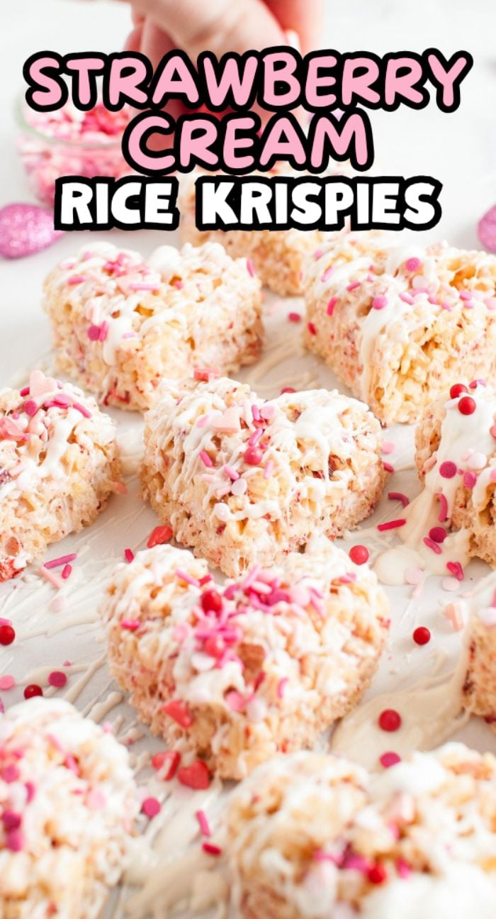 Heart-shaped strawberry rice krispie treats with pink sprinkles, freeze dried strawberries, and a white drizzle, labeled "Strawberry Cream Rice Krispies.