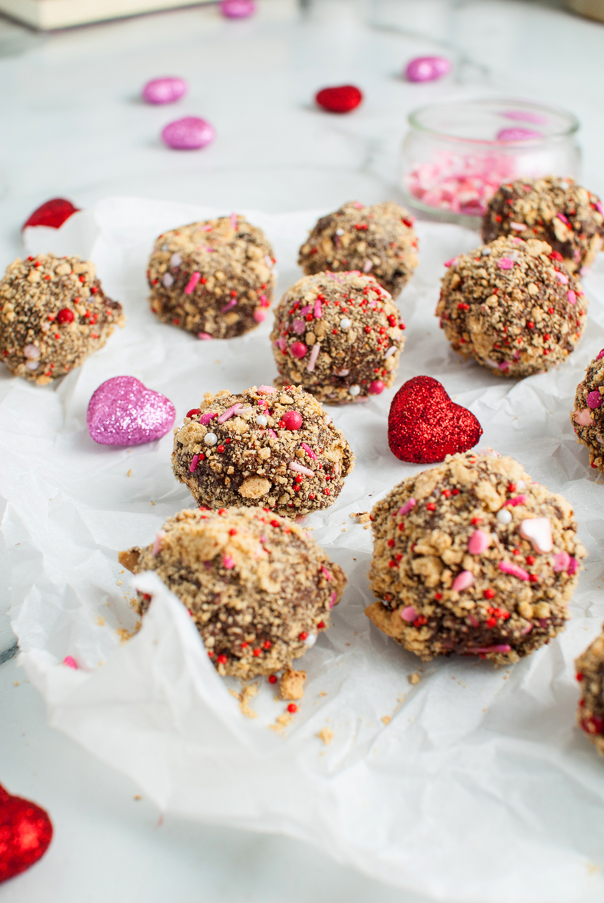 Chocolate truffles coated in crushed cookies and sprinkles with heart decorations make an easy Valentine treat, perfect for parties or gifting. Try using a boxed brownie mix for a shortcut, inspired by classic Valentine S'mores Brownie Bites.