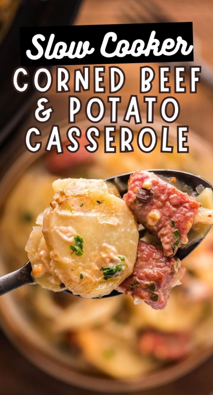 A spoonful of Slow Cooker Corned Beef and Potato Casserole with creamy sauce, herbs, and tender potatoes and pepper jack cheese, above a bowl.