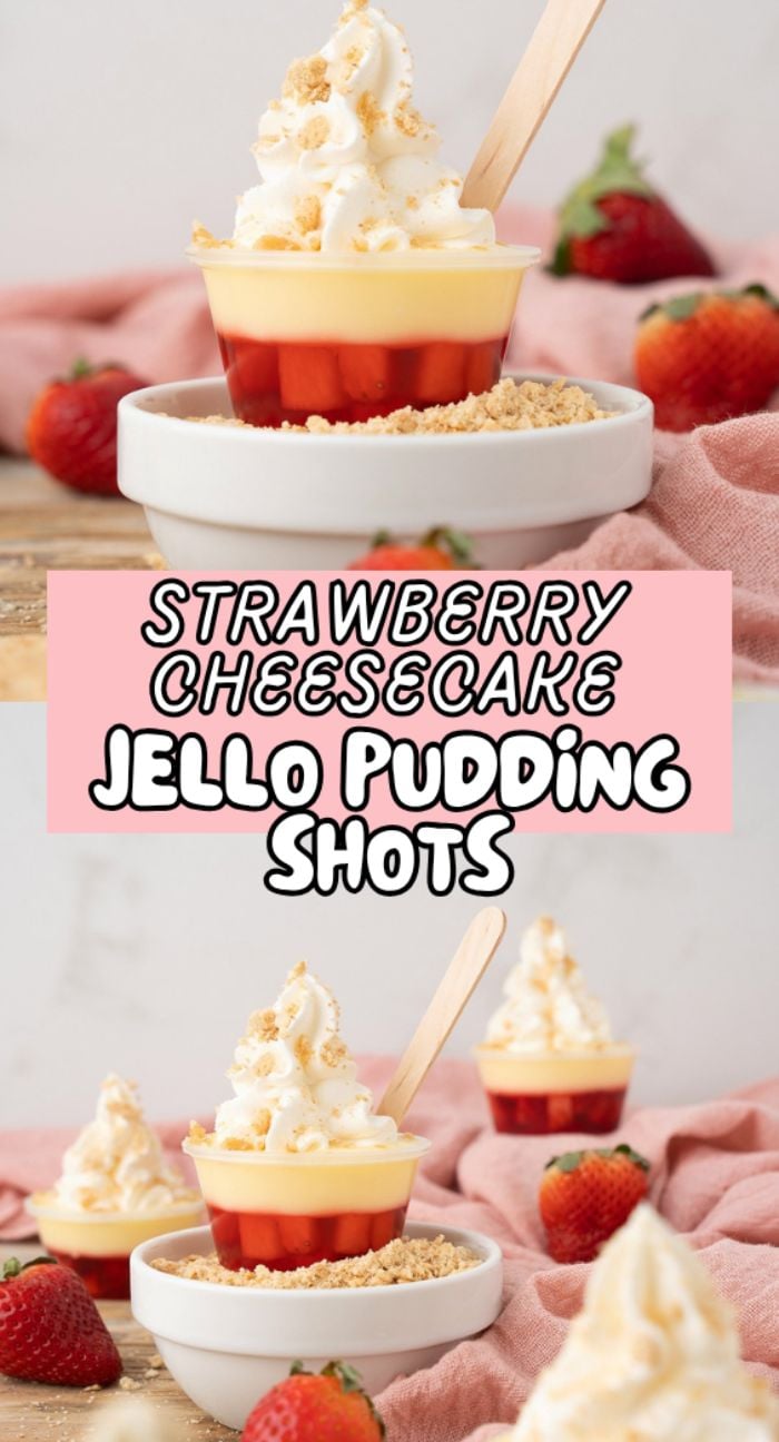 Two Strawberry Cheesecake Jello Pudding Shots topped with whipped cream and crumbs, surrounded by fresh strawberries—a delightful strawberry dessert cocktail perfect for any occasion.