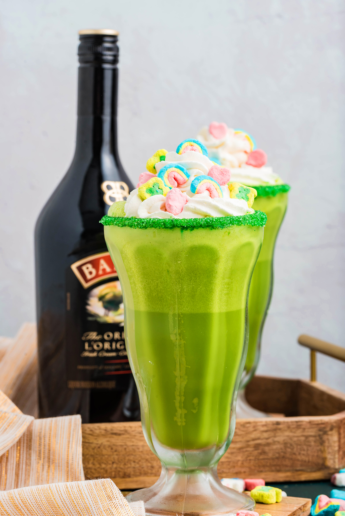 A festive St. Patrick's shake topped with whipped cream and candy sprinkles, perfect for celebrating with a sweet, creamy twist.