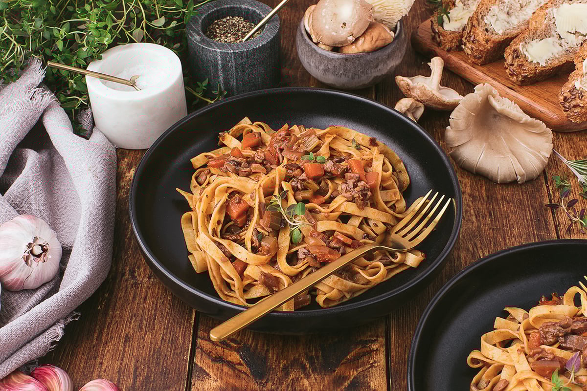 Pasta with a mushroom ragu served on a plate plate.