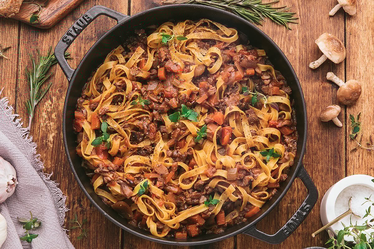A plate of pasta with mushroom sauce.