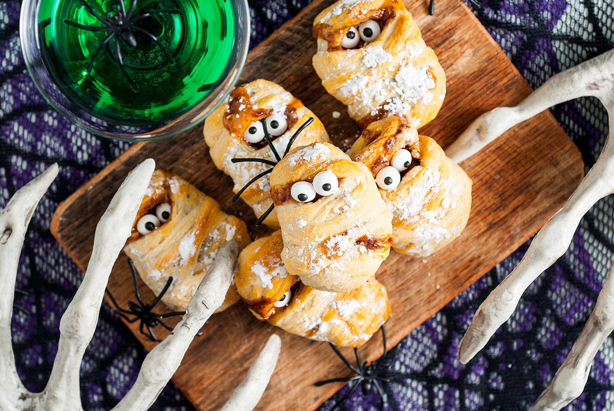 Halloween Snickers Mummy Treats on a cutting board.