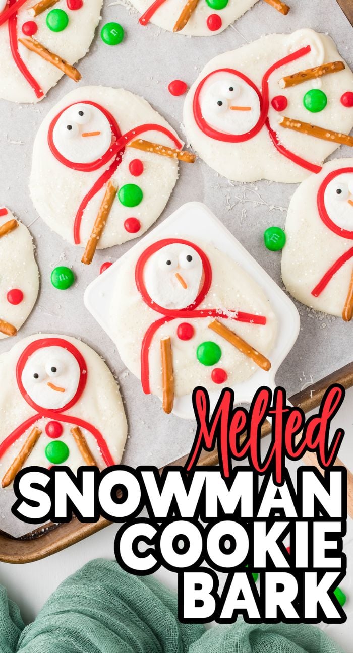 Cookies decorated as melted snowmen with pretzel arms and candy details, on a baking tray—perfect for holiday parties. Text reads "Melted Snowman Cookie Bark.
