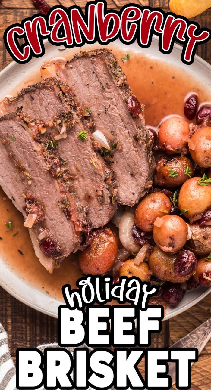 Sliced beef brisket with cranberries and potatoes on a plate, labeled “Cranberry Holiday Beef Brisket”—the perfect centerpiece for a festive holiday meal or thanksgiving or christmas dinner.