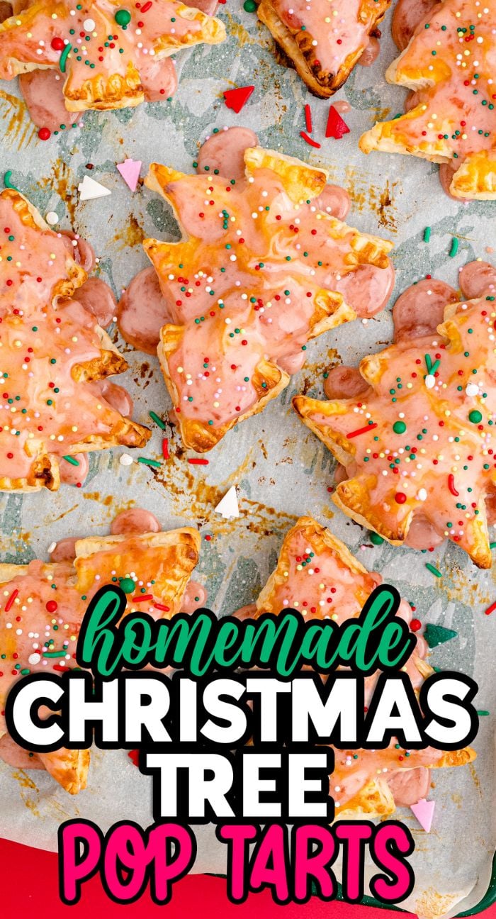 Christmas Tree Pop Tarts with pink icing and festive sprinkles on parchment paper—perfect for adding a whimsical touch to your favorite christmas dessert tart recipes.