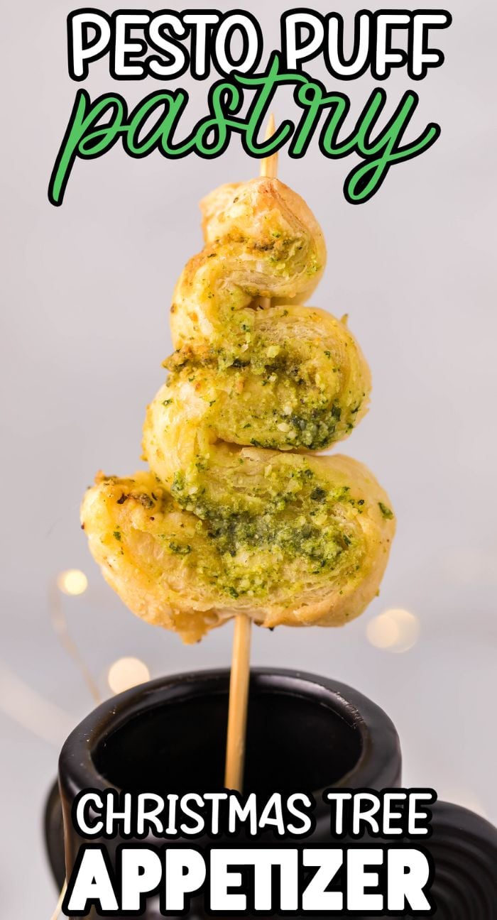 A festive pesto puff pastry shaped like a Christmas tree on a stick, perfect as Pesto Puff Pastry Christmas Trees for your holiday spread. An easy and delightful choice among Christmas appetizers from any puff pastry recipe collection.