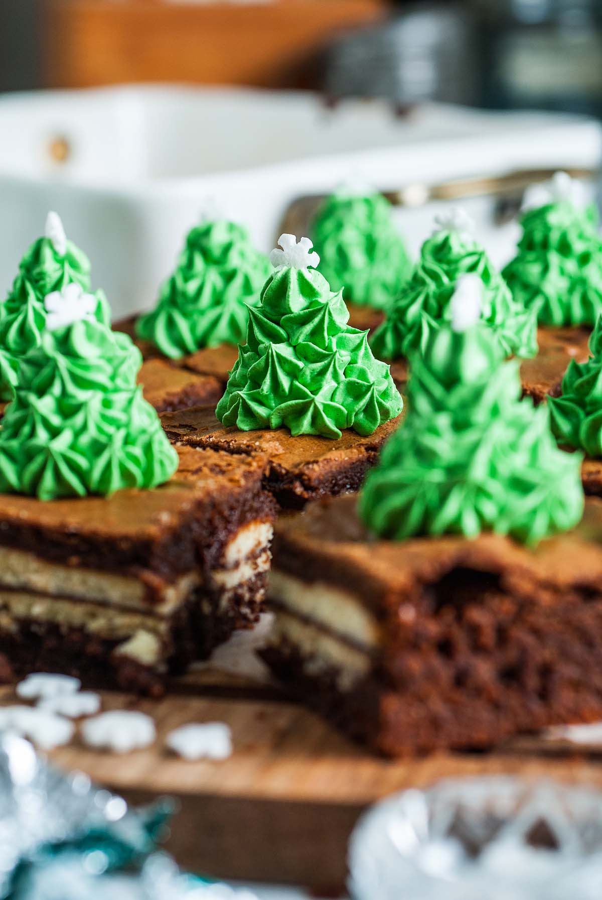 Mint brownies cut into squares and decorated with a Christmas tree of green frosting and white star sprinkles, these Mint Milano Christmas Brownies are a festive holiday treat.