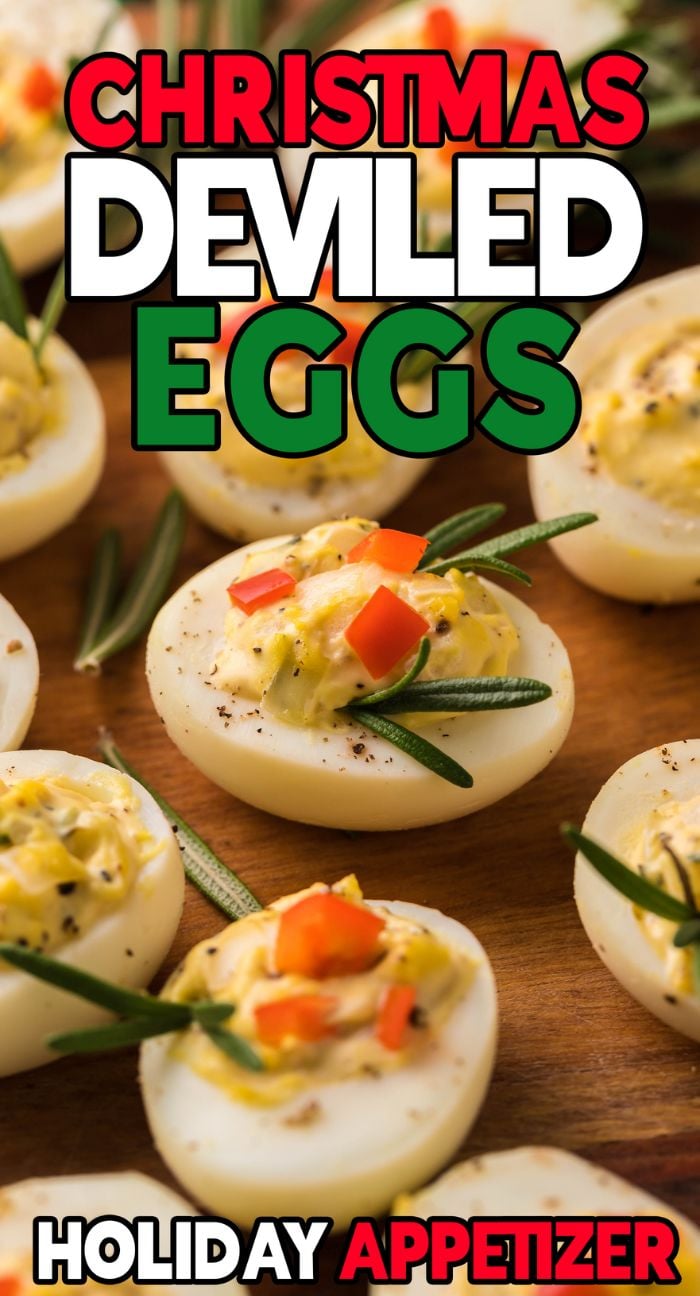 Deviled eggs garnished with herbs and red peppers on a wooden board, perfect as a holiday appetizer for your Christmas party.