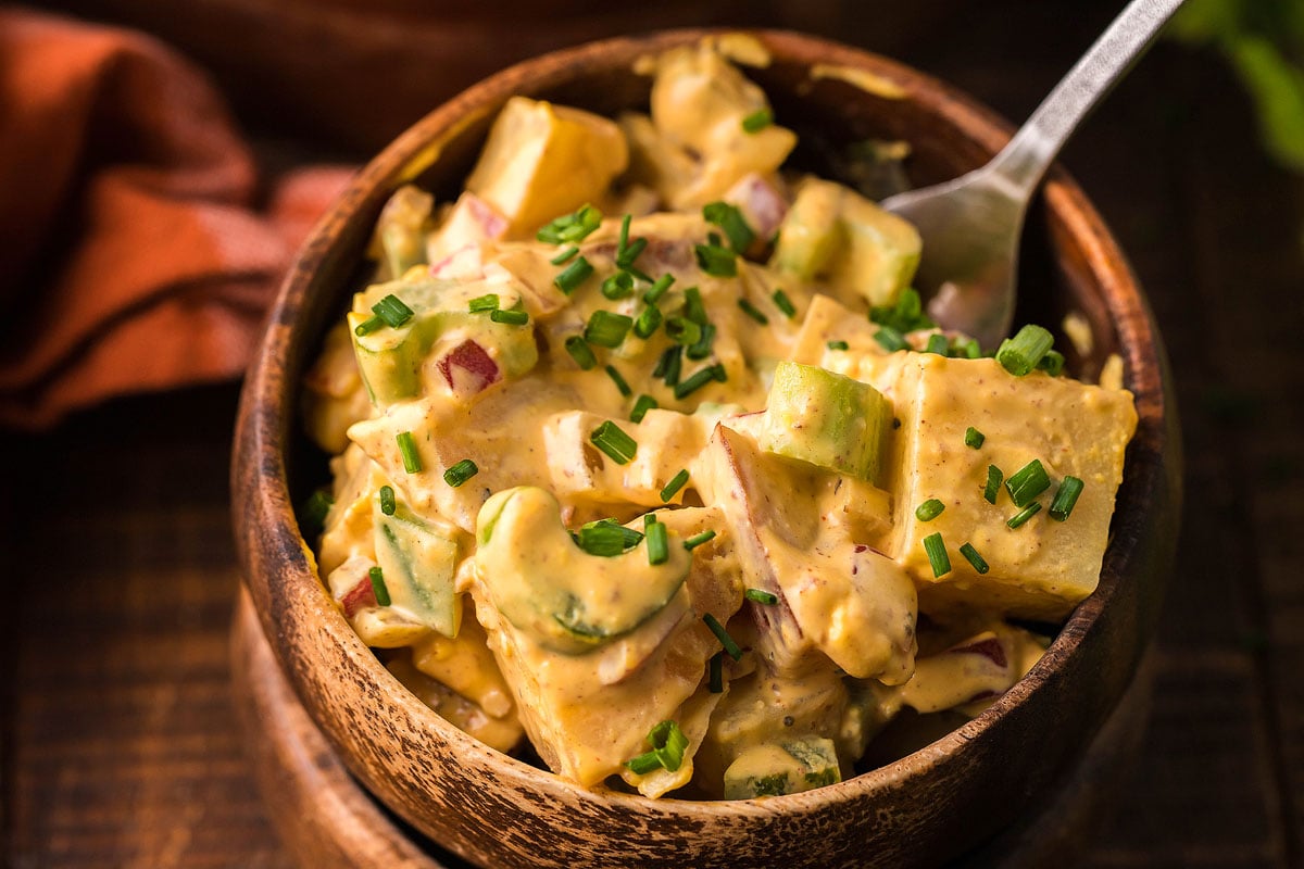 Smoked potato salad in a wooden bowl.