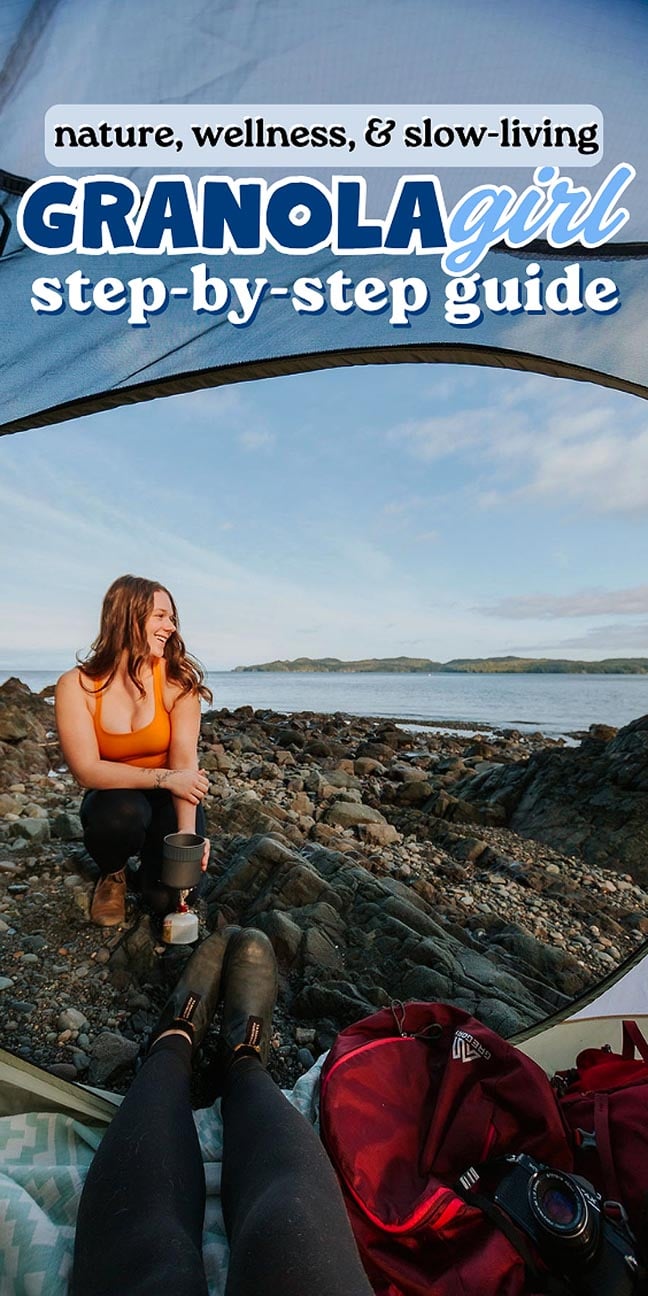 Woman in orange top sits by rocky shore, viewed from inside a tent, with gear and ocean in background, capturing the outdoorsy charm of the granola girl aesthetic.