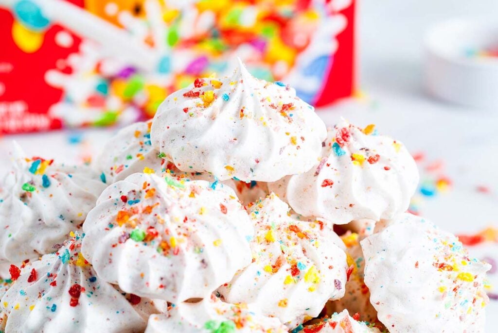 A stack of meringe cookies made with Fruity Pebbles cereal. 