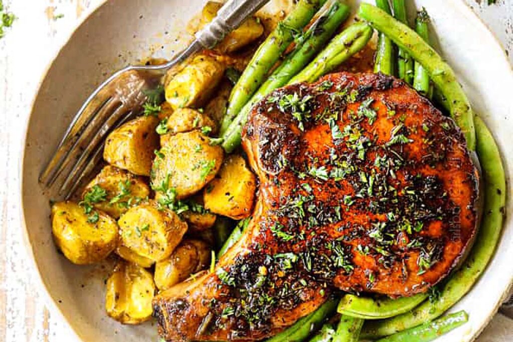 Pork chops served on a plate.
