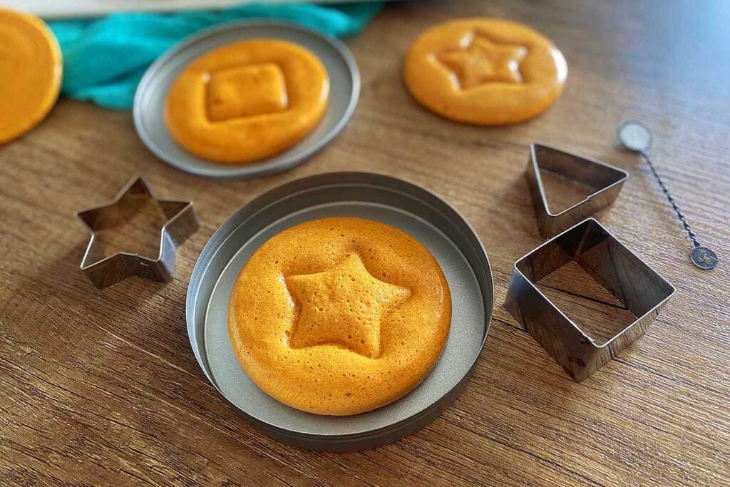 Dalgona candy on a pan with shapers