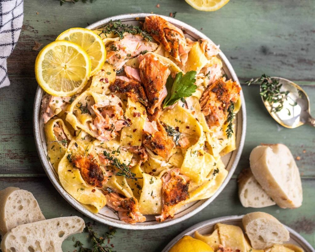 A salmon pasta dish on a plate.