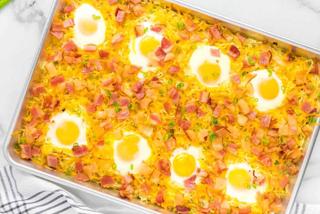 Sheet pan breakfast with eggs on top.