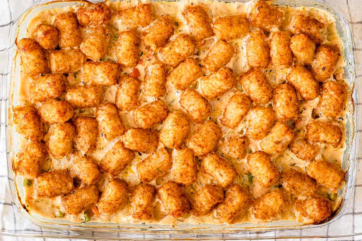 A casserole filled with creamy chicken and veggies with tater tot topping.